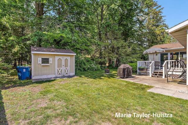 16205 Suffolk Dr, Spring Lake, MI 49456 - view of grassy yard with a shed, a deck, a patio area, and an AC wall unit