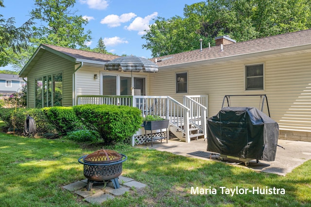 16205 Suffolk Dr, Spring Lake, MI 49456 - back of house featuring a fire pit, a yard, a shingled roof, and a patio