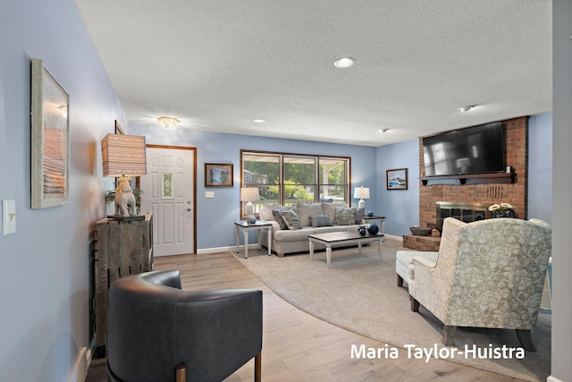 16205 Suffolk Dr, Spring Lake, MI 49456 - living area with a textured ceiling, wood finished floors, and a brick fireplace