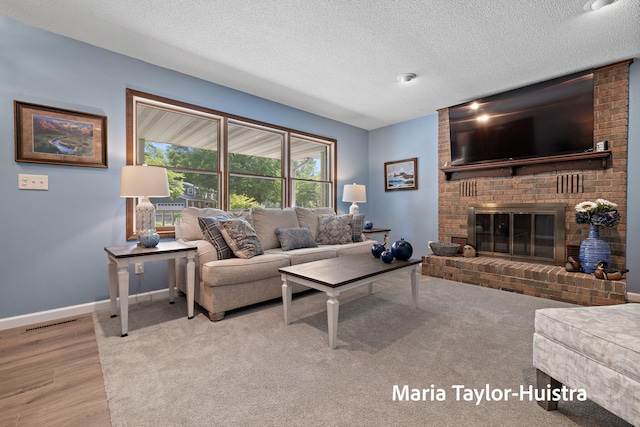 16205 Suffolk Dr, Spring Lake, MI 49456 - living area featuring a textured ceiling, wood finished floors, and a fireplace