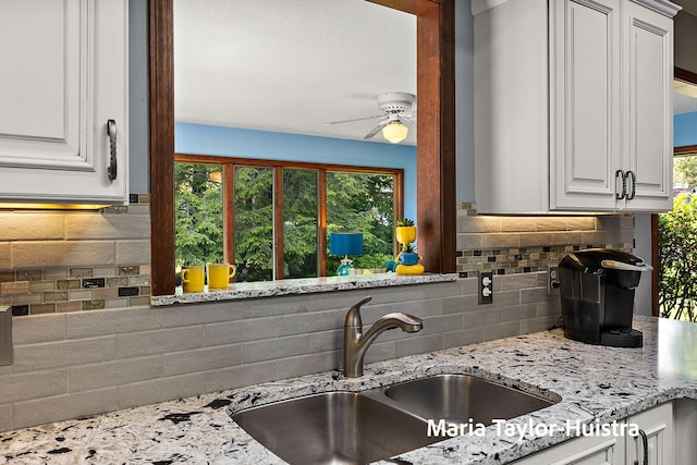 16205 Suffolk Dr, Spring Lake, MI 49456 - kitchen featuring tasteful backsplash, ceiling fan, light stone countertops, and white cabinetry