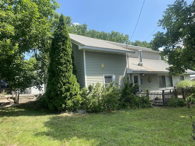 126 E Maple St, Muir, MI 48860 - rear view of property featuring a metal roof