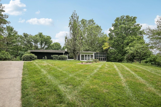 2373 Belgrade Notch St, Ann Arbor, MI 48103 - view of green lawn with a sunroom