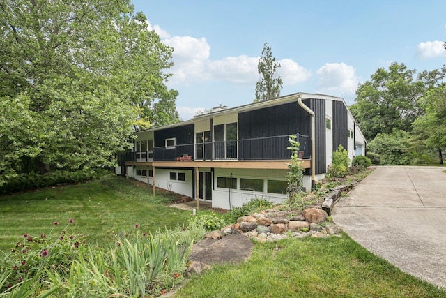 2373 Belgrade Notch St, Ann Arbor, MI 48103 - back of house with a sunroom and a yard