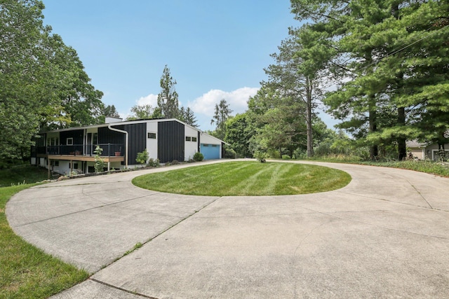 2373 Belgrade Notch St, Ann Arbor, MI 48103 - view of front facade with a garage, a front lawn, and curved driveway