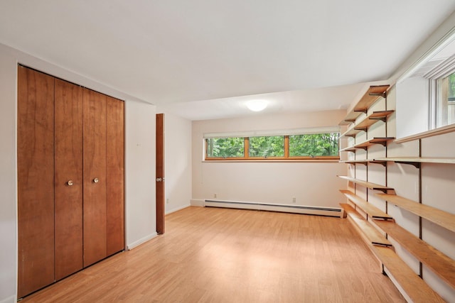 2373 Belgrade Notch St, Ann Arbor, MI 48103 - unfurnished bedroom featuring baseboard heating, light wood-style flooring, and a closet
