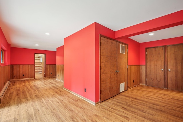 2373 Belgrade Notch St, Ann Arbor, MI 48103 - spare room with wood finished floors, wainscoting, wood walls, recessed lighting, and baseboard heating