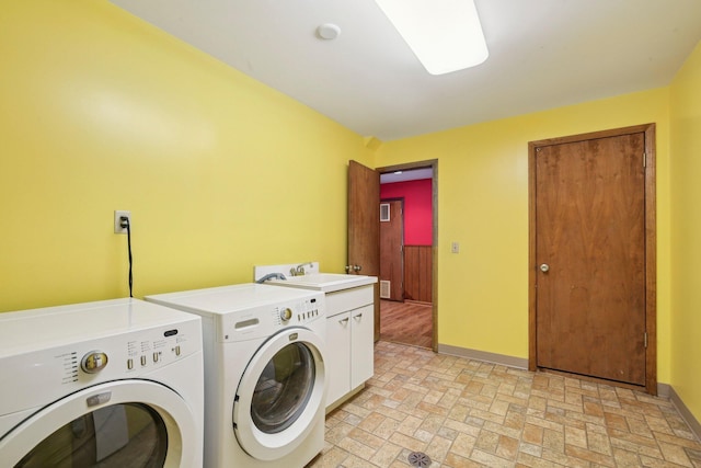 2373 Belgrade Notch St, Ann Arbor, MI 48103 - laundry area featuring cabinet space, washing machine and clothes dryer, and brick patterned floors