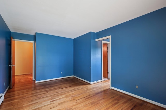 2373 Belgrade Notch St, Ann Arbor, MI 48103 - empty room featuring wood finished floors and a baseboard radiator