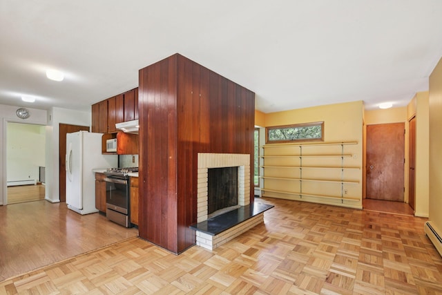 2373 Belgrade Notch St, Ann Arbor, MI 48103 - kitchen with white appliances, a brick fireplace, a baseboard radiator, under cabinet range hood, and a baseboard heating unit