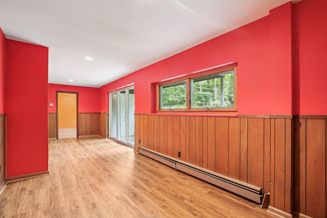 2373 Belgrade Notch St, Ann Arbor, MI 48103 - unfurnished room with a baseboard heating unit, wainscoting, wood finished floors, wooden walls, and recessed lighting