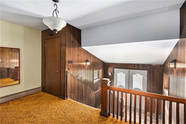 258 Division St, Eastlake, MI 49626 - hallway featuring an upstairs landing, carpet floors, a baseboard radiator, and wooden walls