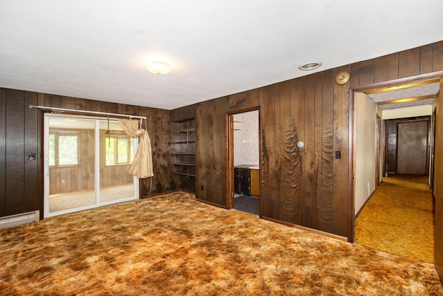 258 Division St, Eastlake, MI 49626 - unfurnished bedroom with wooden walls and carpet