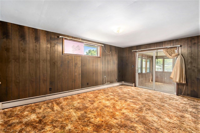 258 Division St, Eastlake, MI 49626 - carpeted empty room featuring healthy amount of natural light, a baseboard heating unit, and wooden walls