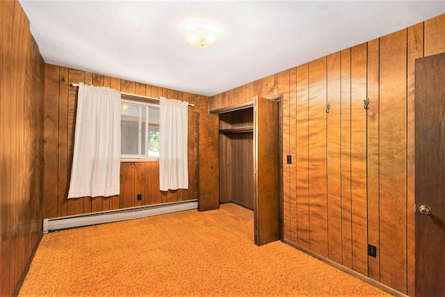 258 Division St, Eastlake, MI 49626 - unfurnished bedroom with a baseboard radiator, carpet flooring, wooden walls, and a closet