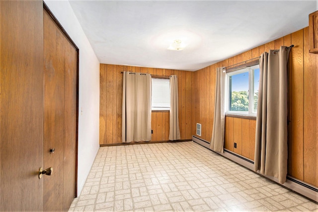 258 Division St, Eastlake, MI 49626 - unfurnished bedroom with brick patterned flooring and wooden walls