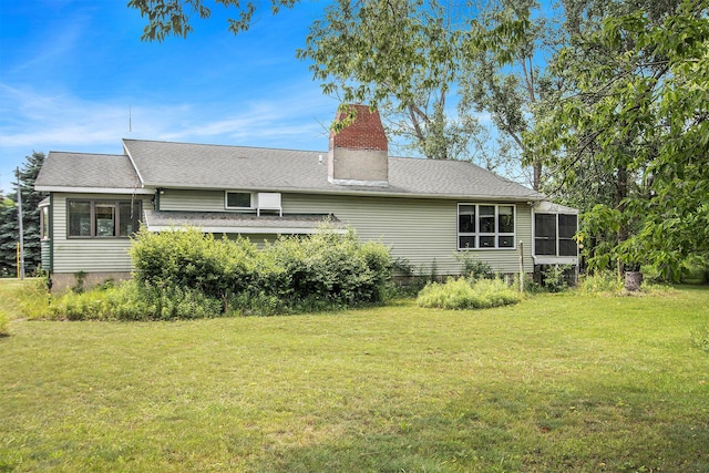 258 Division St, Eastlake, MI 49626 - back of property featuring a lawn, a chimney, and a sunroom
