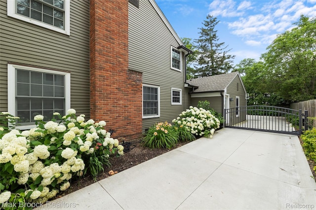 639 N Glenhurst Dr, Birmingham, MI 48009 - view of home's exterior with a gate and concrete driveway