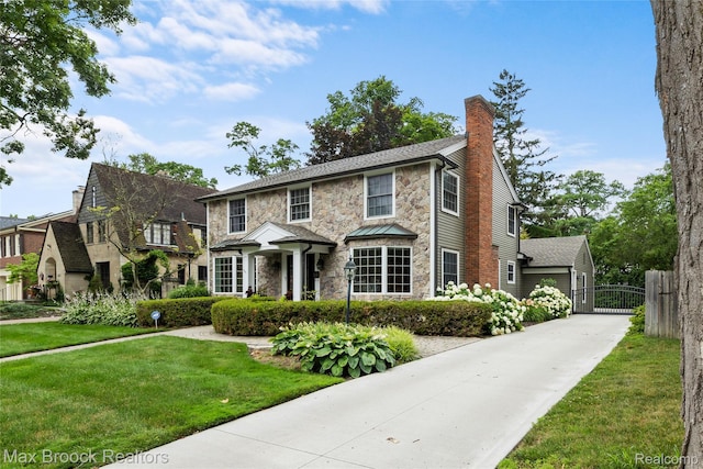 639 N Glenhurst Dr, Birmingham, MI 48009 - view of front of home featuring stone siding, a chimney, a gate, and driveway
