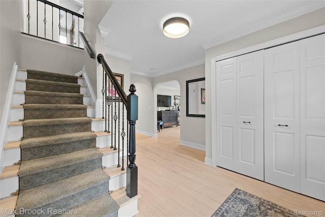 639 N Glenhurst Dr, Birmingham, MI 48009 - staircase featuring ornamental molding, arched walkways, and wood finished floors