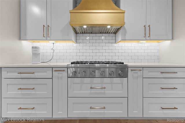 639 N Glenhurst Dr, Birmingham, MI 48009 - kitchen featuring custom range hood, light countertops, stainless steel gas cooktop, and decorative backsplash