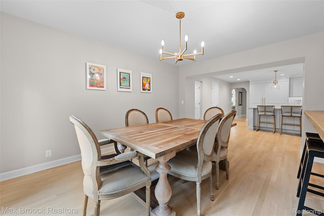 639 N Glenhurst Dr, Birmingham, MI 48009 - dining space featuring arched walkways, light wood finished floors, a chandelier, and recessed lighting