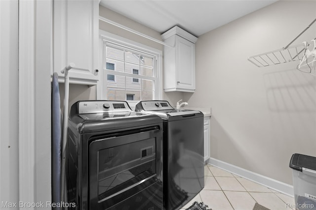 639 N Glenhurst Dr, Birmingham, MI 48009 - laundry area featuring independent washer and dryer, cabinet space, and light tile patterned flooring