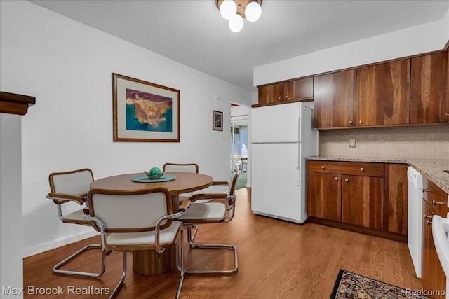 2419 Avondale St W, Sylvan Lake, MI 48320 - kitchen with freestanding refrigerator, backsplash, wood finished floors, and light stone counters