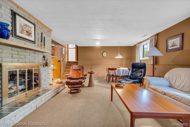 2419 Avondale St W, Sylvan Lake, MI 48320 - living room featuring carpet, stairs, a fireplace, and a wainscoted wall
