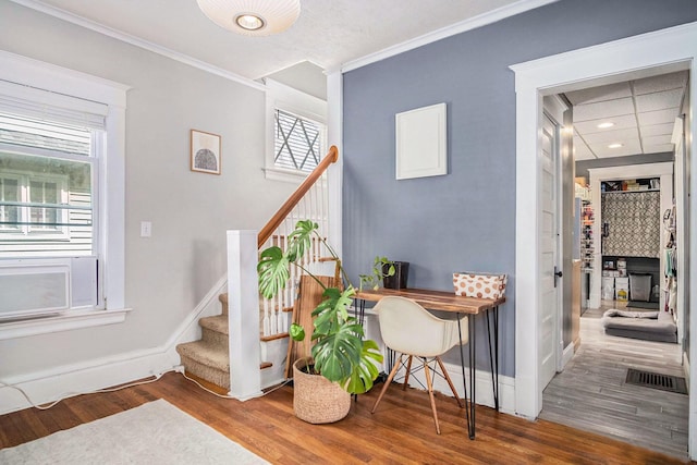 1200 Sherman St SE, Grand Rapids, MI 49506 - staircase with wood finished floors, crown molding, a fireplace, and recessed lighting