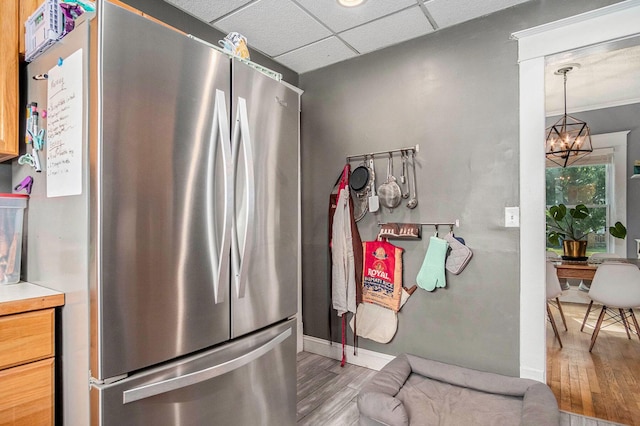 1200 Sherman St SE, Grand Rapids, MI 49506 - kitchen featuring freestanding refrigerator, light wood-style flooring, a chandelier, and a drop ceiling