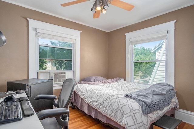 1200 Sherman St SE, Grand Rapids, MI 49506 - bedroom featuring wood finished floors, multiple windows, crown molding, a ceiling fan, and cooling unit
