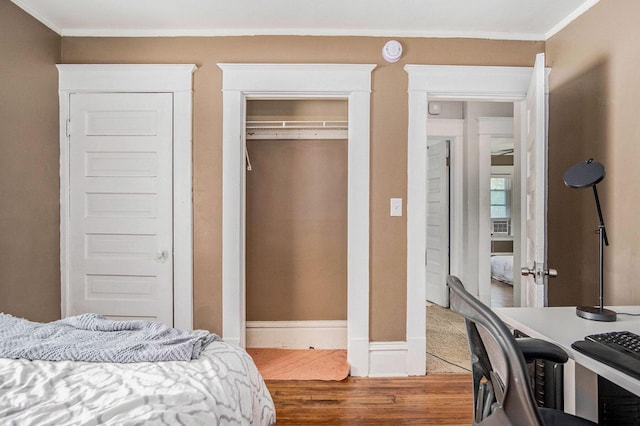 1200 Sherman St SE, Grand Rapids, MI 49506 - bedroom with wood finished floors, ornamental molding, a closet, and cooling unit