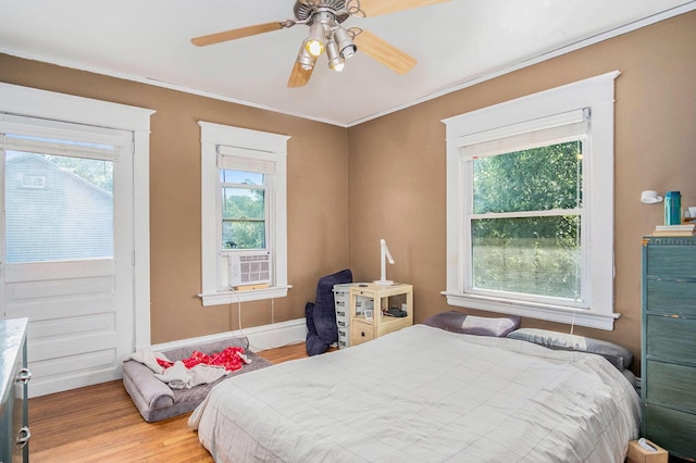 1200 Sherman St SE, Grand Rapids, MI 49506 - bedroom featuring wood finished floors, cooling unit, ornamental molding, and a ceiling fan