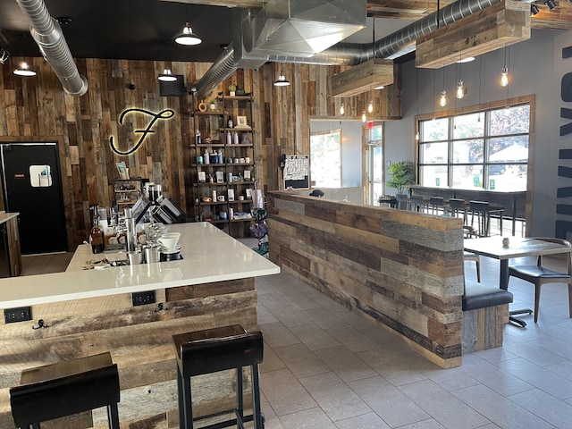 1200 Sherman St SE, Grand Rapids, MI 49506 - bar area featuring wooden walls, freestanding refrigerator, and tile patterned flooring