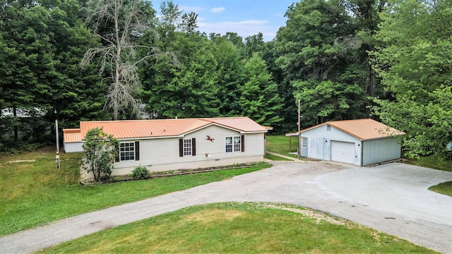 2141 S Parsons Ave, Fremont, MI 49412 - view of front of property featuring an outdoor structure, a detached garage, a metal roof, a front lawn, and crawl space