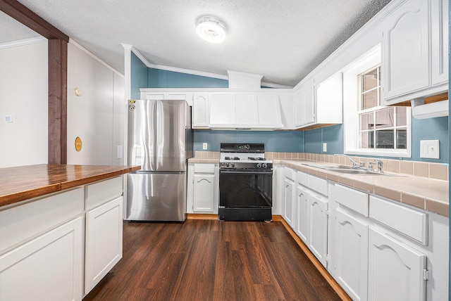 2141 S Parsons Ave, Fremont, MI 49412 - kitchen featuring gas stove, freestanding refrigerator, vaulted ceiling, ornamental molding, and white cabinets