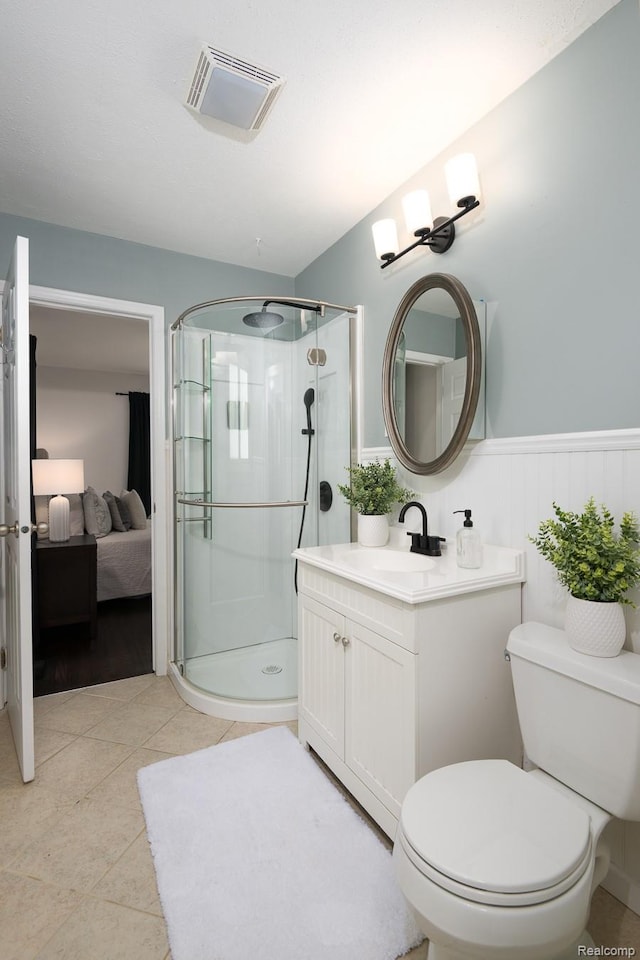 3410 N Main St, Royal Oak, MI 48073 - bathroom with a stall shower, vanity, ensuite bathroom, tile patterned floors, and a wainscoted wall