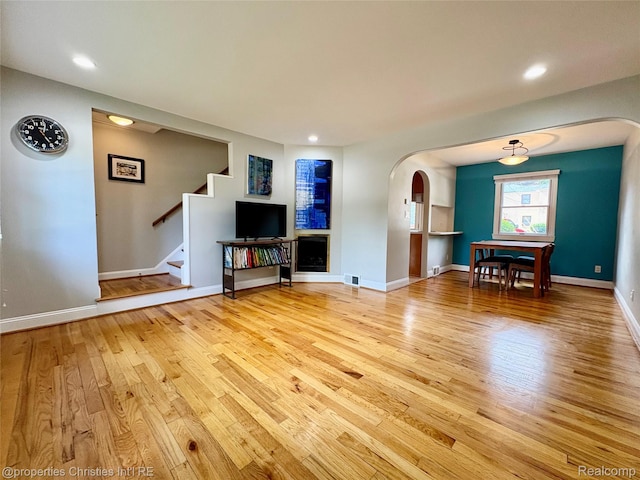 1983 Graefield Rd, Birmingham, MI 48009 - unfurnished living room with arched walkways, light wood-type flooring, stairs, and recessed lighting