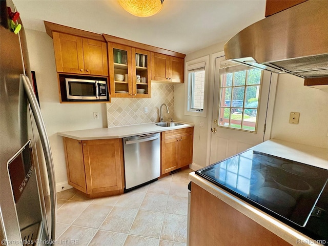 1983 Graefield Rd, Birmingham, MI 48009 - kitchen with stainless steel appliances, exhaust hood, brown cabinets, tasteful backsplash, and light tile patterned flooring