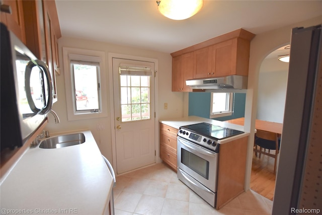 1983 Graefield Rd, Birmingham, MI 48009 - kitchen featuring appliances with stainless steel finishes, exhaust hood, arched walkways, light countertops, and light tile patterned floors