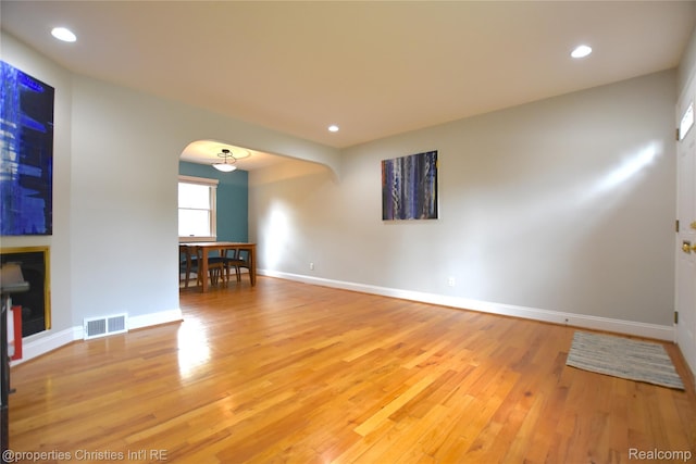 1983 Graefield Rd, Birmingham, MI 48009 - empty room with arched walkways, wood finished floors, recessed lighting, and a fireplace