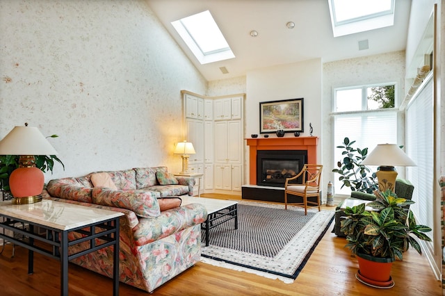 5 Mission Rdg, Frankenmuth, MI 48734 - living area with a skylight, a glass covered fireplace, wood finished floors, and high vaulted ceiling