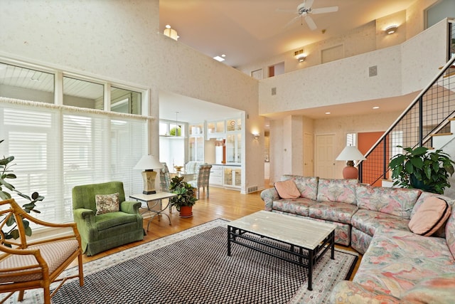 5 Mission Rdg, Frankenmuth, MI 48734 - living area featuring a ceiling fan, a high ceiling, wood finished floors, and stairway