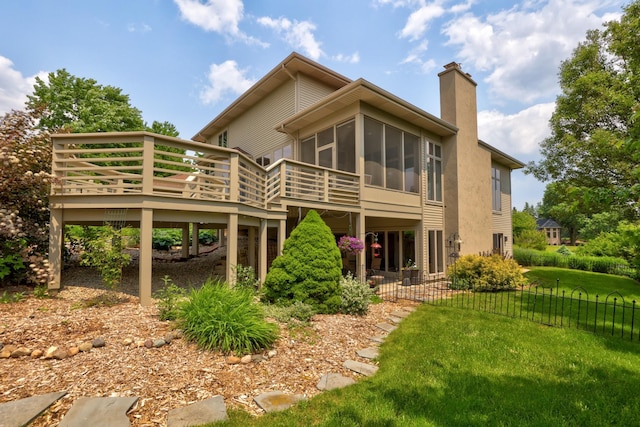 5 Mission Rdg, Frankenmuth, MI 48734 - back of house featuring a deck, a yard, a sunroom, and a chimney