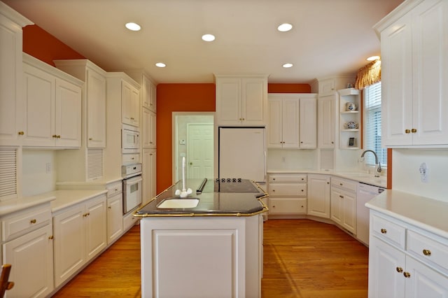 5 Mission Rdg, Frankenmuth, MI 48734 - kitchen with white appliances, white cabinets, a kitchen island, light wood-style floors, and recessed lighting