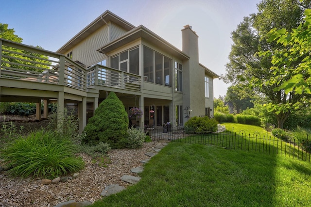 5 Mission Rdg, Frankenmuth, MI 48734 - rear view of property with a wooden deck, a sunroom, and a chimney