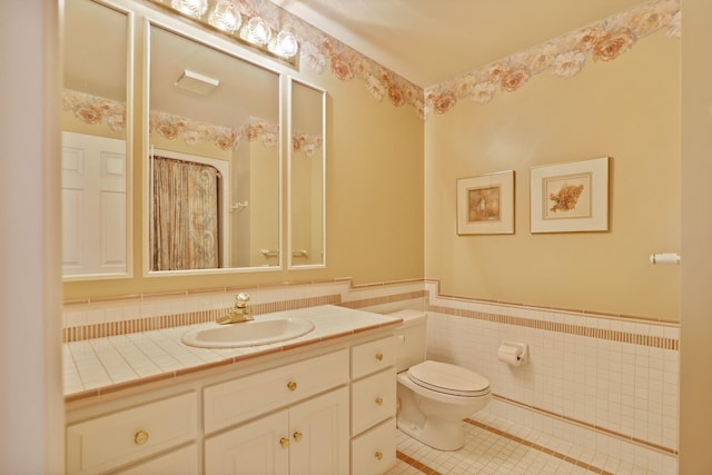 5 Mission Rdg, Frankenmuth, MI 48734 - bathroom featuring tile patterned floors, vanity, wainscoting, and tile walls