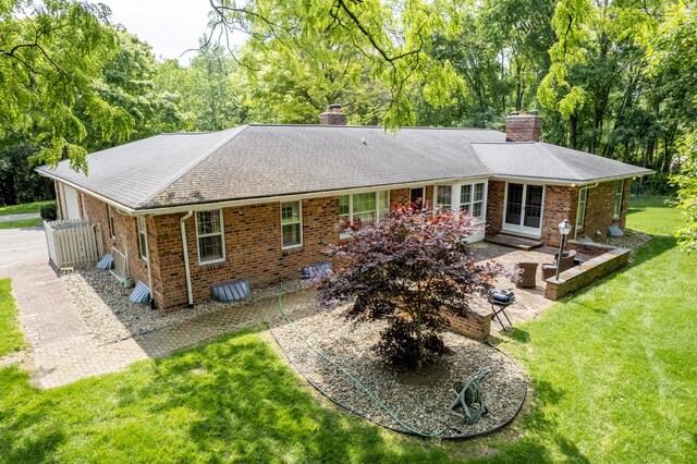 144 Barton N Dr, Ann Arbor, MI 48105 - back of house featuring a chimney, brick siding, and a patio area