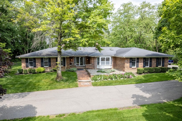 144 Barton N Dr, Ann Arbor, MI 48105 - ranch-style house with brick siding, a front lawn, and a chimney
